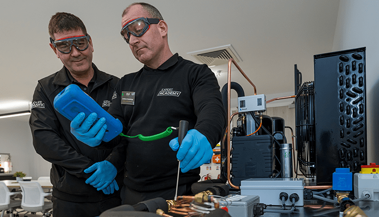 Two male heat pump engineers using a probe at Ideal Heatings new training centre in Dunstable