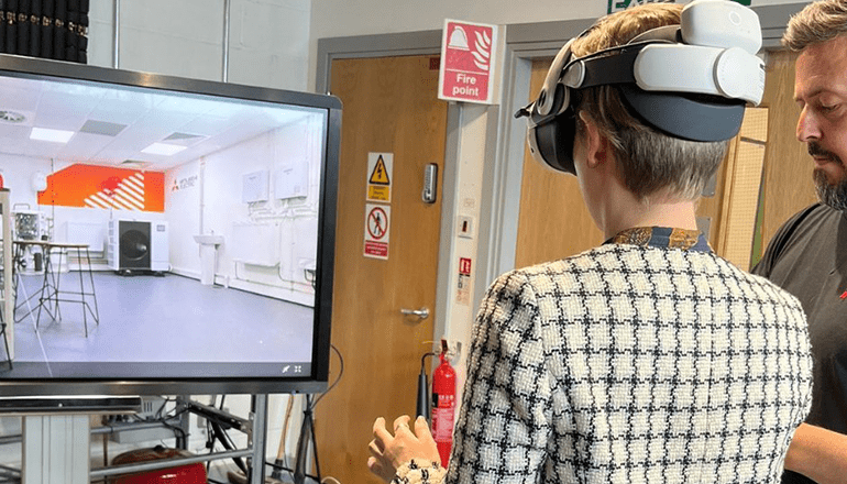 rear view of a woman using a VR headset in a heat pump training centre