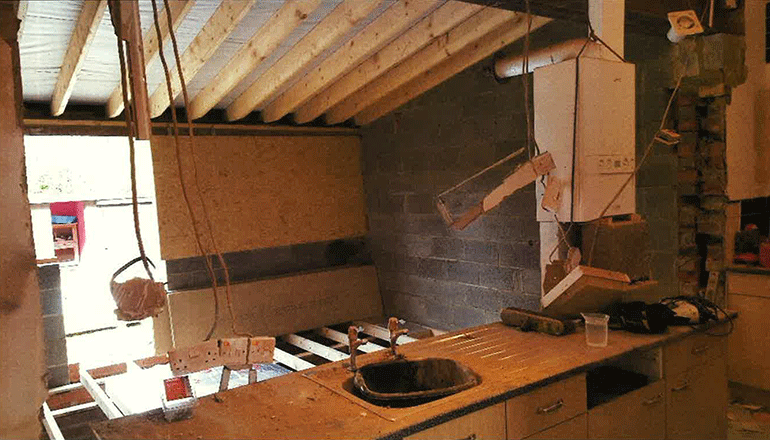 Building work in a kitchen with boiler left in a dangerous position