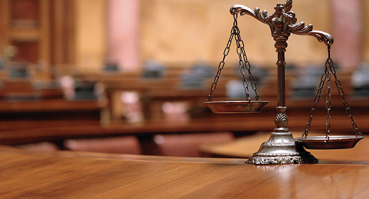 Image of scales on a desk, signifying justice