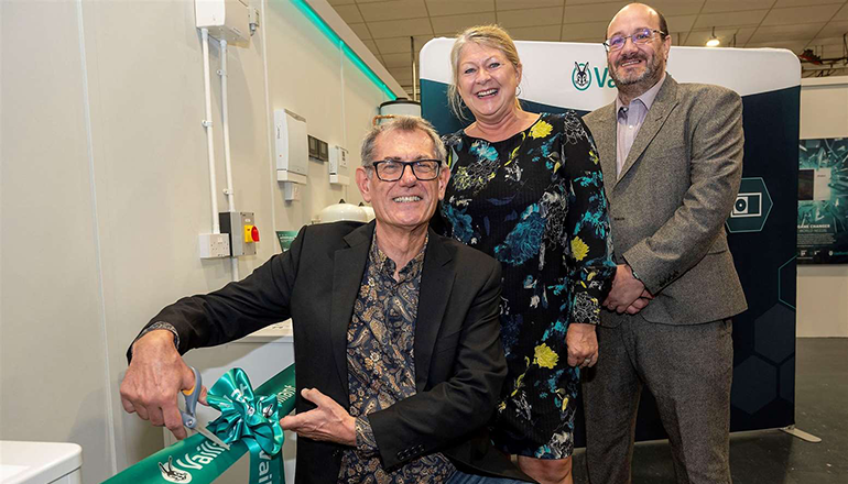 3 people, 2 men and 1 woman, cutting the ribbon to signify the opening of Vaillant's new heat pump training centre at WEST SUFFOLK COLLEGE